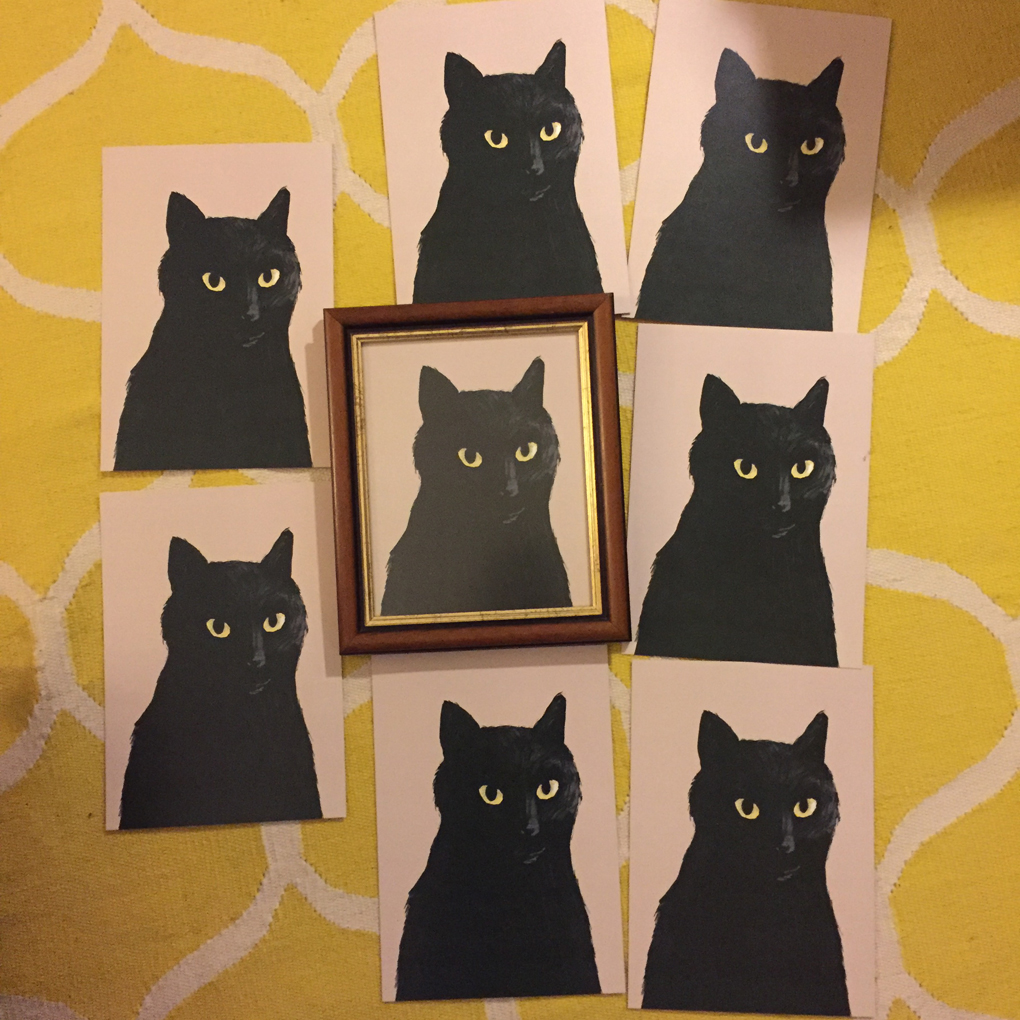 8 identical art prints of a black cat