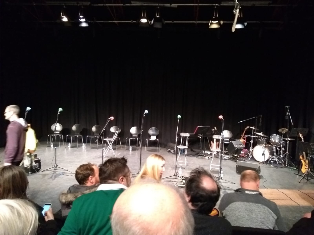 seats on a stage at a recording