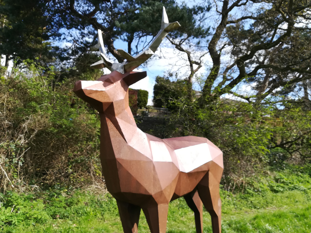 A statue of a deer, made of flat shapes