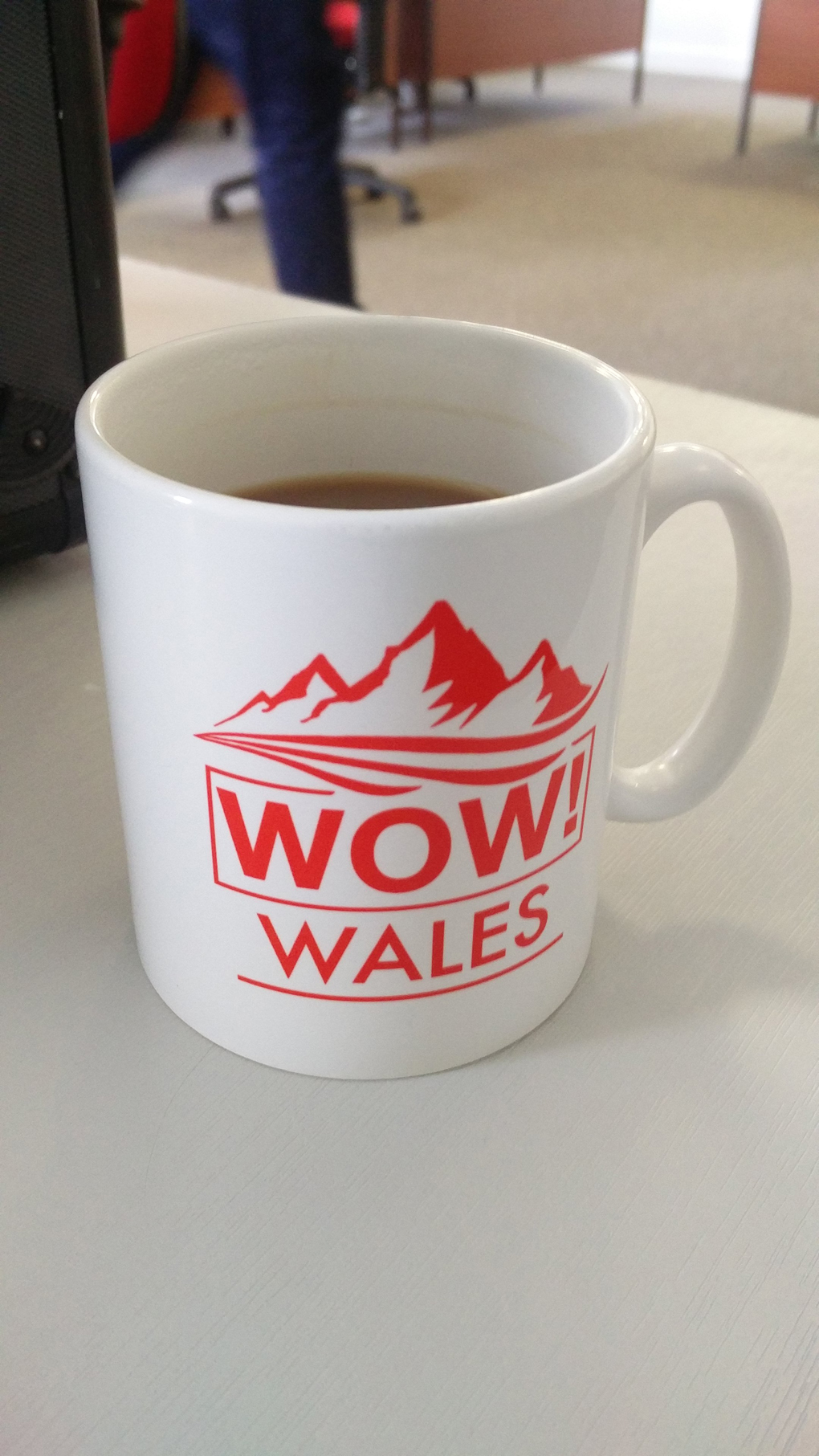 white mug with 'Wow! Wales!' printed on it in red