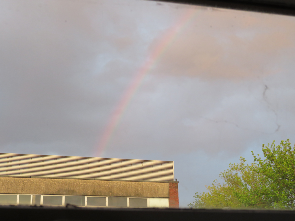 A rainbow is framed by a rectangular window