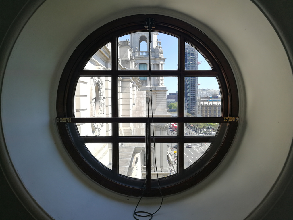 impressive white stone architecture through a circular window