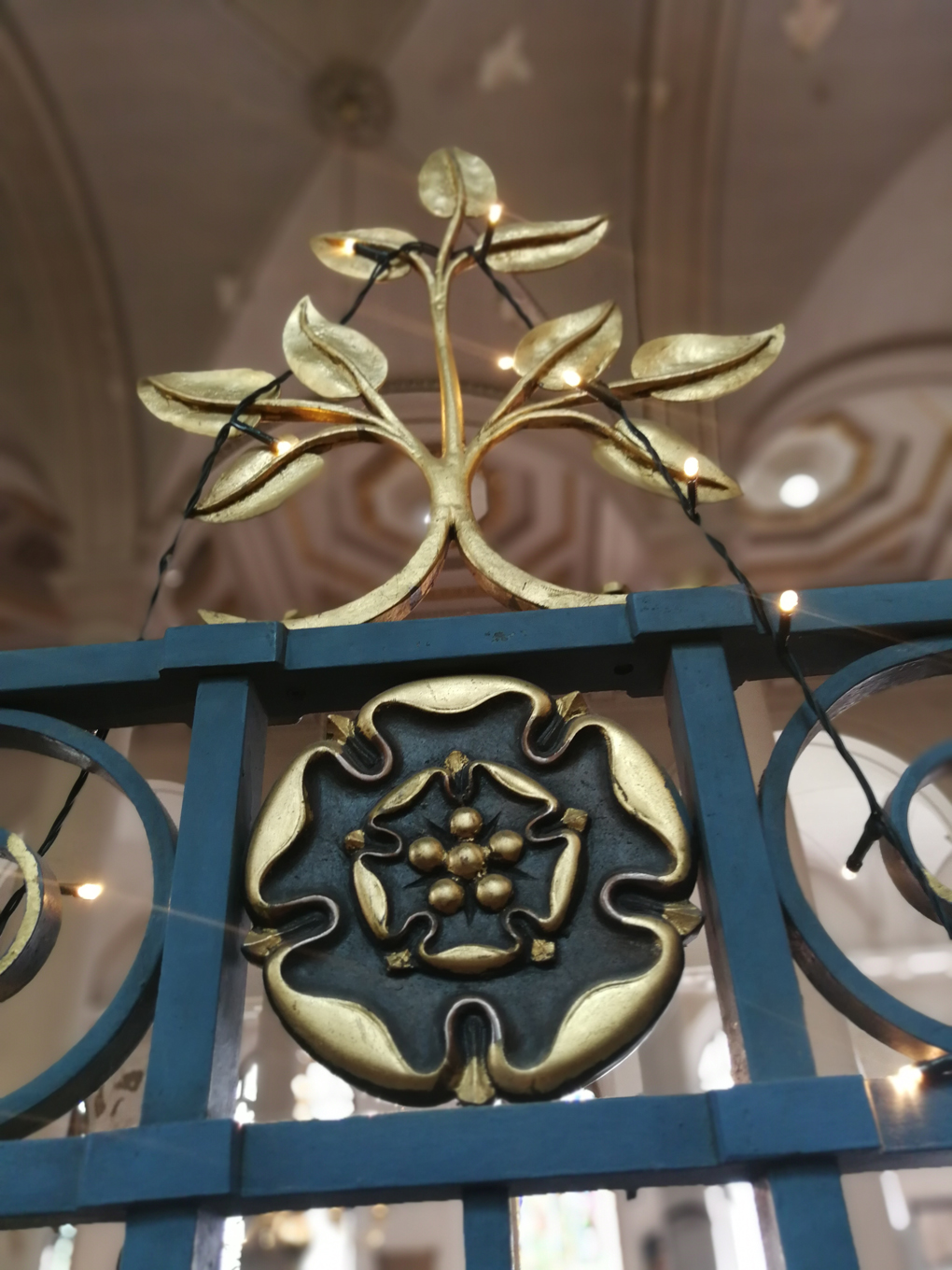 blue and gold painted ironwork in the shape of flowers and leaves