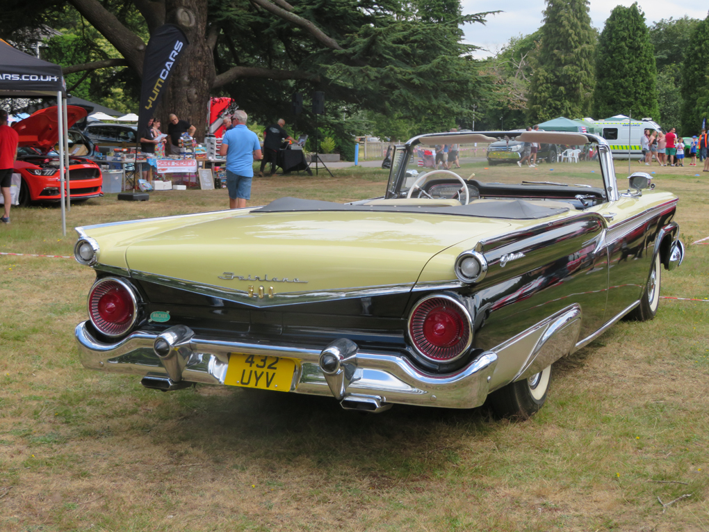 Rear 3/4 shot of a black and gold 1959 Ford sunliner Convertible