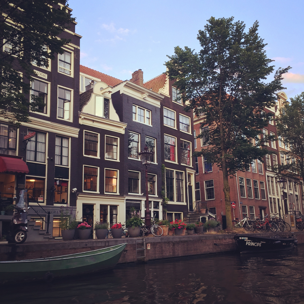 A row of narrow houses in Amsterdam overlooking a canal