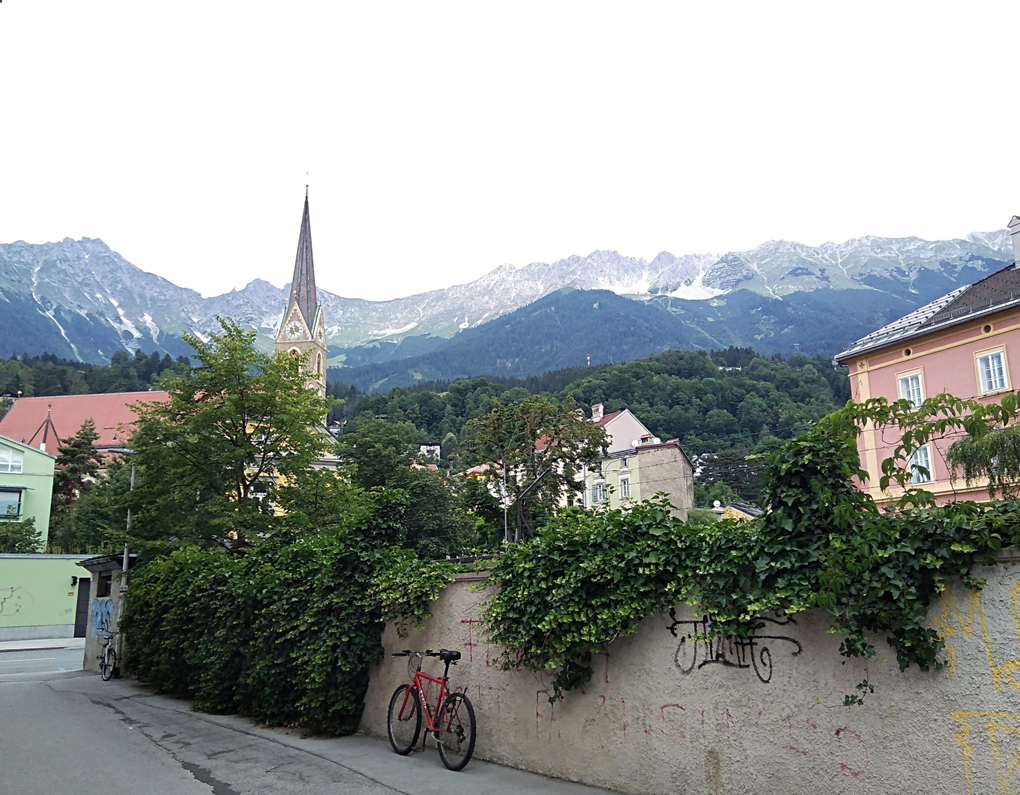 This picture shows a quiet residential area of Innsbruck backed by an impressive mountain range.