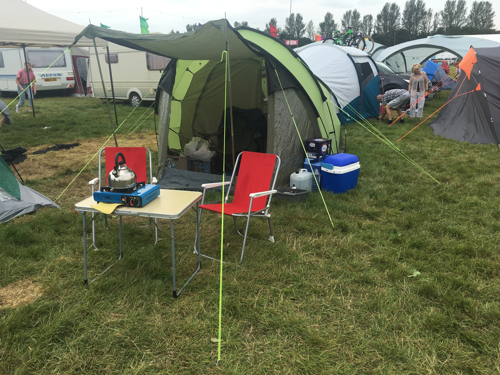 We see a picture of a welcoming tent with canopy and appliances read for cooking