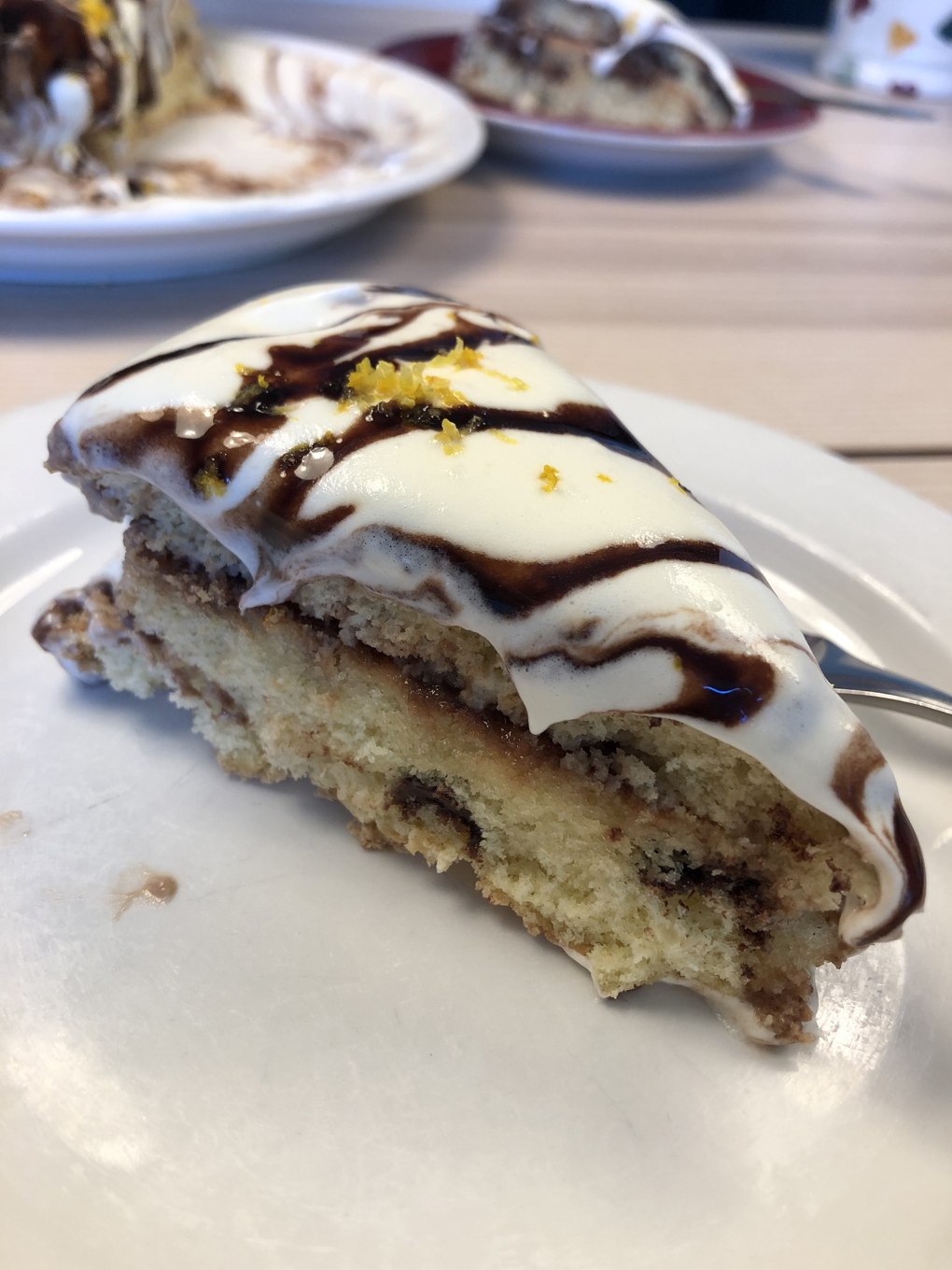 A slice of cake with creamy topping