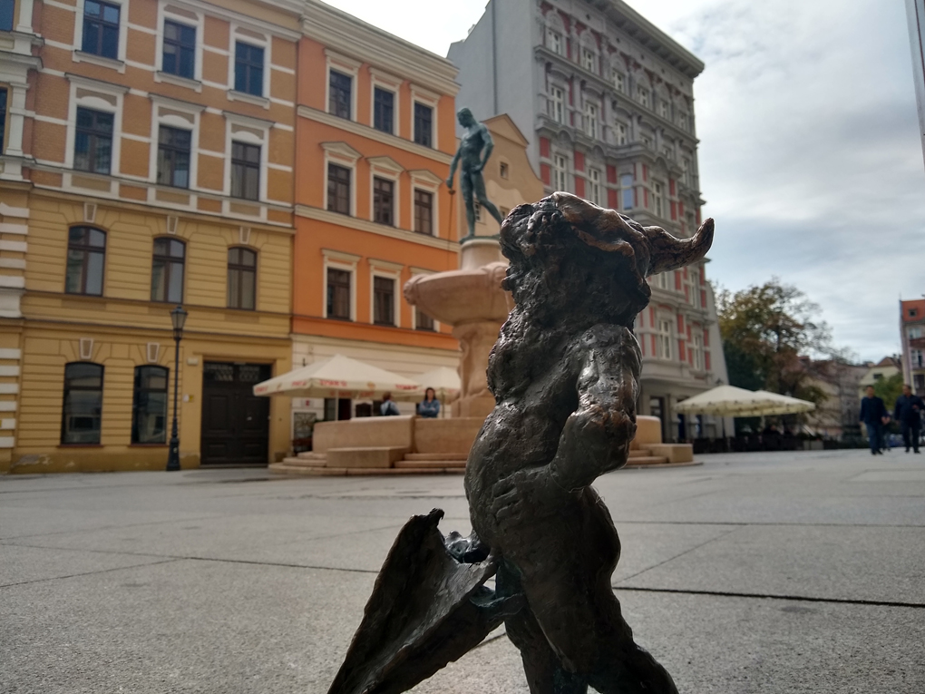 Dwarf with umbrella in front of Fencer fountain in Wrocław