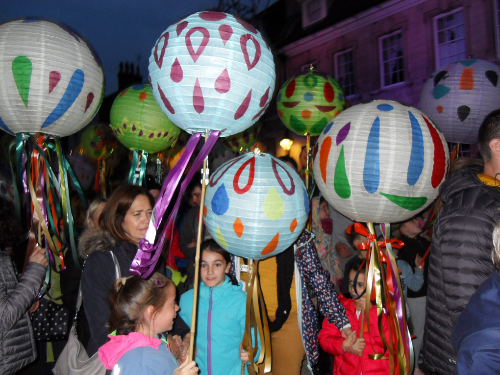 Children and adults with colourful paper lanterns