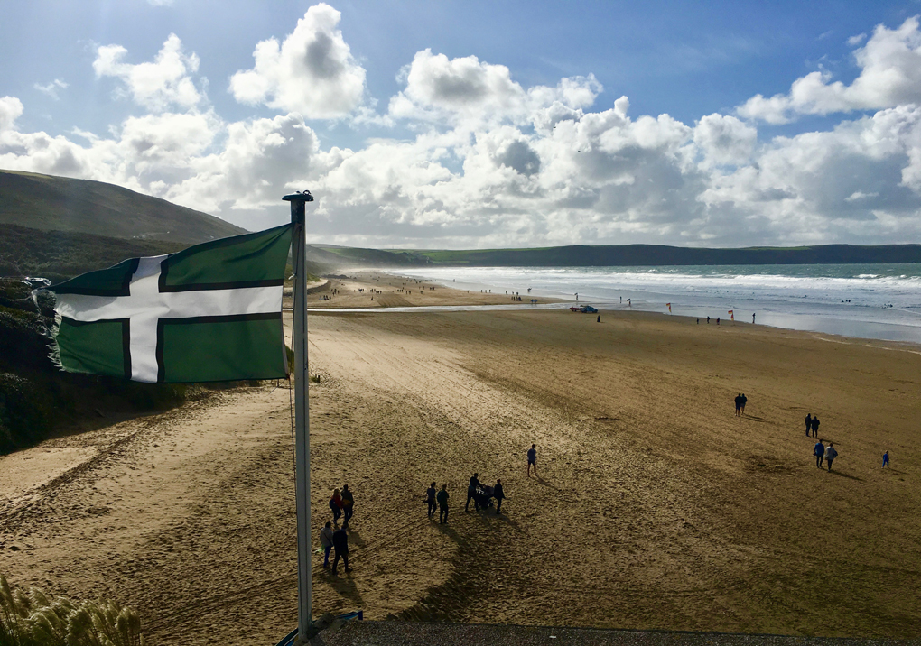 Devon flag fluttering over Woolacombe Bay
