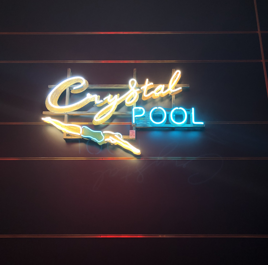 Neon sign of crystal pool with swimmer