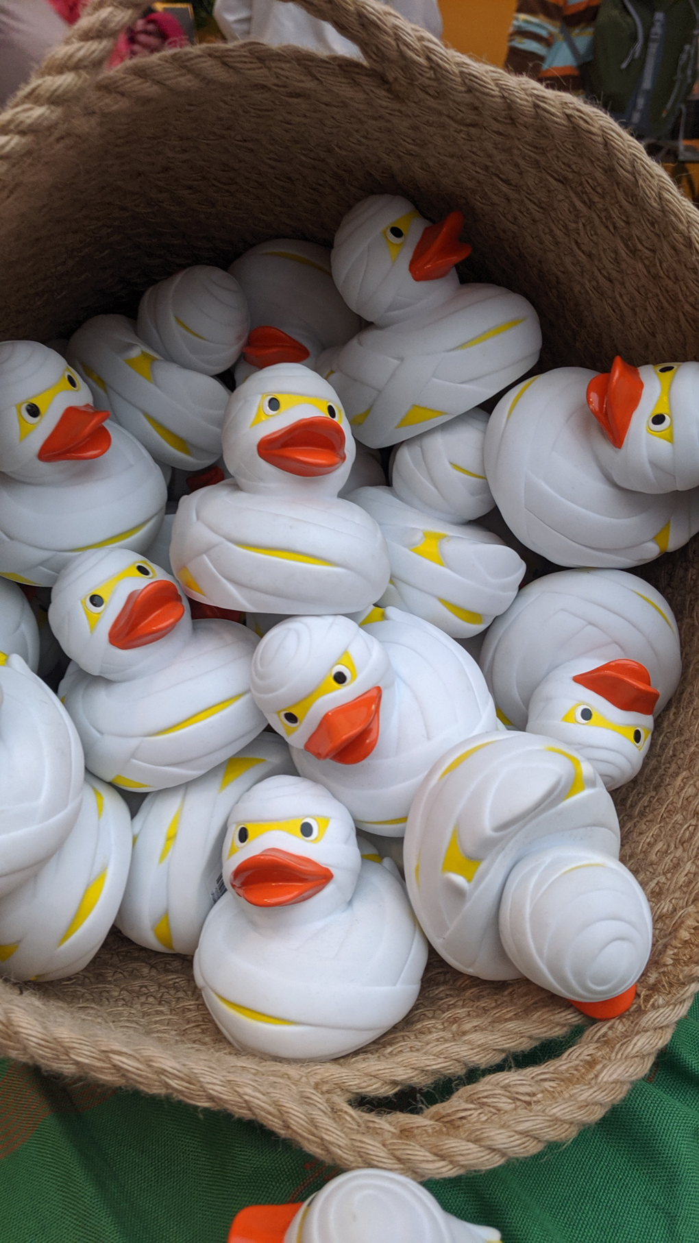 a basket of rubber ducks decorated as if wrapped in bandages to look like an Egyptian mummy