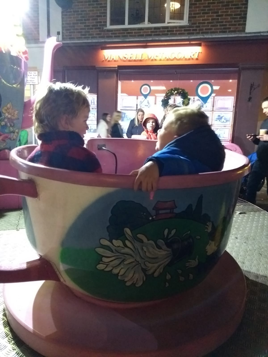 couple of boys on a teacup ride