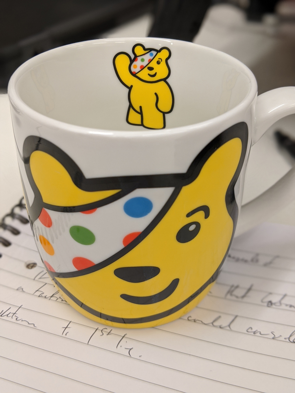 A photo of a mug decorated with a picture of pudsey the bear