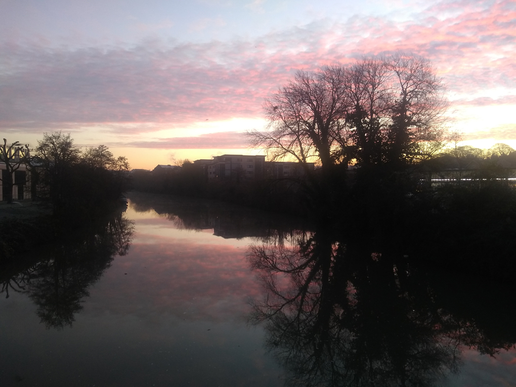View from a bridge over the river at sunrise