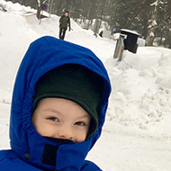 A boy on a sleigh in a snowy scenery