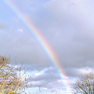 Church with rainbow in sky