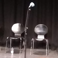 seats on a stage at a recording