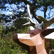 A statue of a deer, made of flat shapes