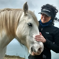 My mum stroking a happy horse