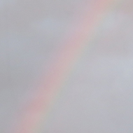 A rainbow is framed by a rectangular window