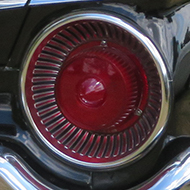 Rear 3/4 shot of a black and gold 1959 Ford sunliner Convertible