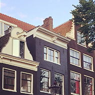 A row of narrow houses in Amsterdam overlooking a canal