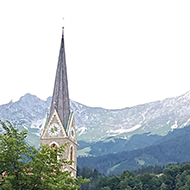 This picture shows a quiet residential area of Innsbruck backed by an impressive mountain range.