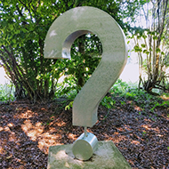 Picture of a sculpted question mark.