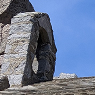 A small stone chapel built into a cliff face.