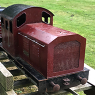 A model train on a track in a garden