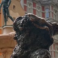 Dwarf with umbrella in front of Fencer fountain in Wrocław