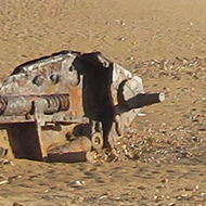 we see the rusting hulls of two WW2 Covenanter tanks half buried in the sand on the beach at Titchwell North Norfolk, with the sand in the background