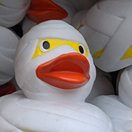 a basket of rubber ducks decorated as if wrapped in bandages to look like an Egyptian mummy