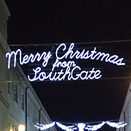 Christmas lights illuminated at night over Bath's open air shopping centre