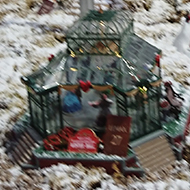 A wintry scene featured on the side of a mountain in minature depicting a village, cable cars, swing boats, a frozen lake, merry go rounds and skiers - brilliant!