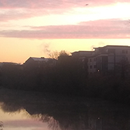 View from a bridge over the river at sunrise