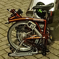 On an empty train station platform in the evening with a Brompton folded up, waiting for the big train to London for the last week of work this year.