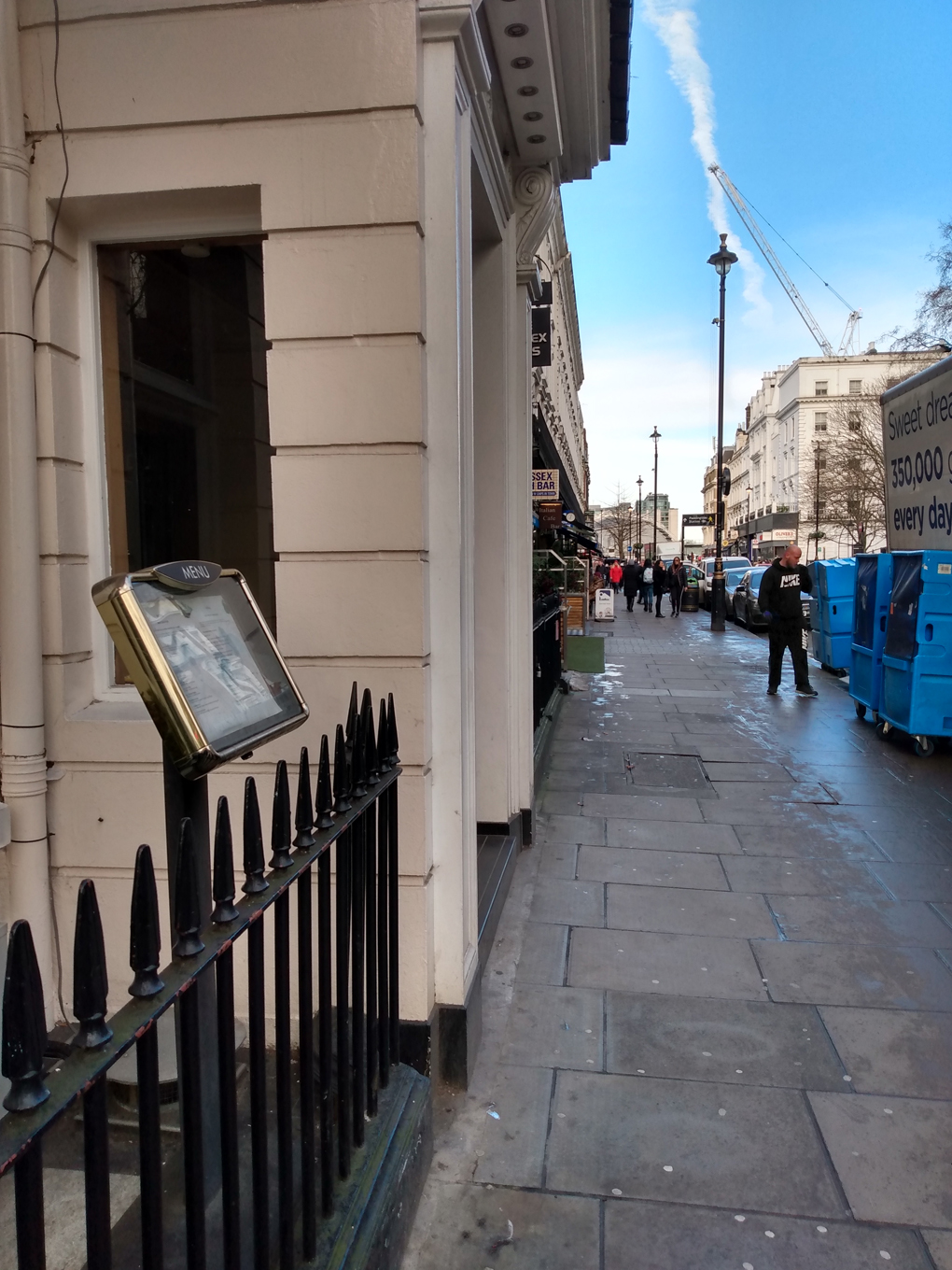 Part of a shop sign with the left side obscured to reveal the apparent sign 'Sex Bar'.