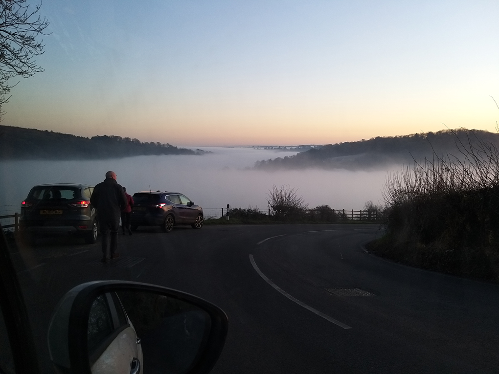 Hill tops jutting out of a sea of mist.  Picture taken from the top of one of the hill tops.