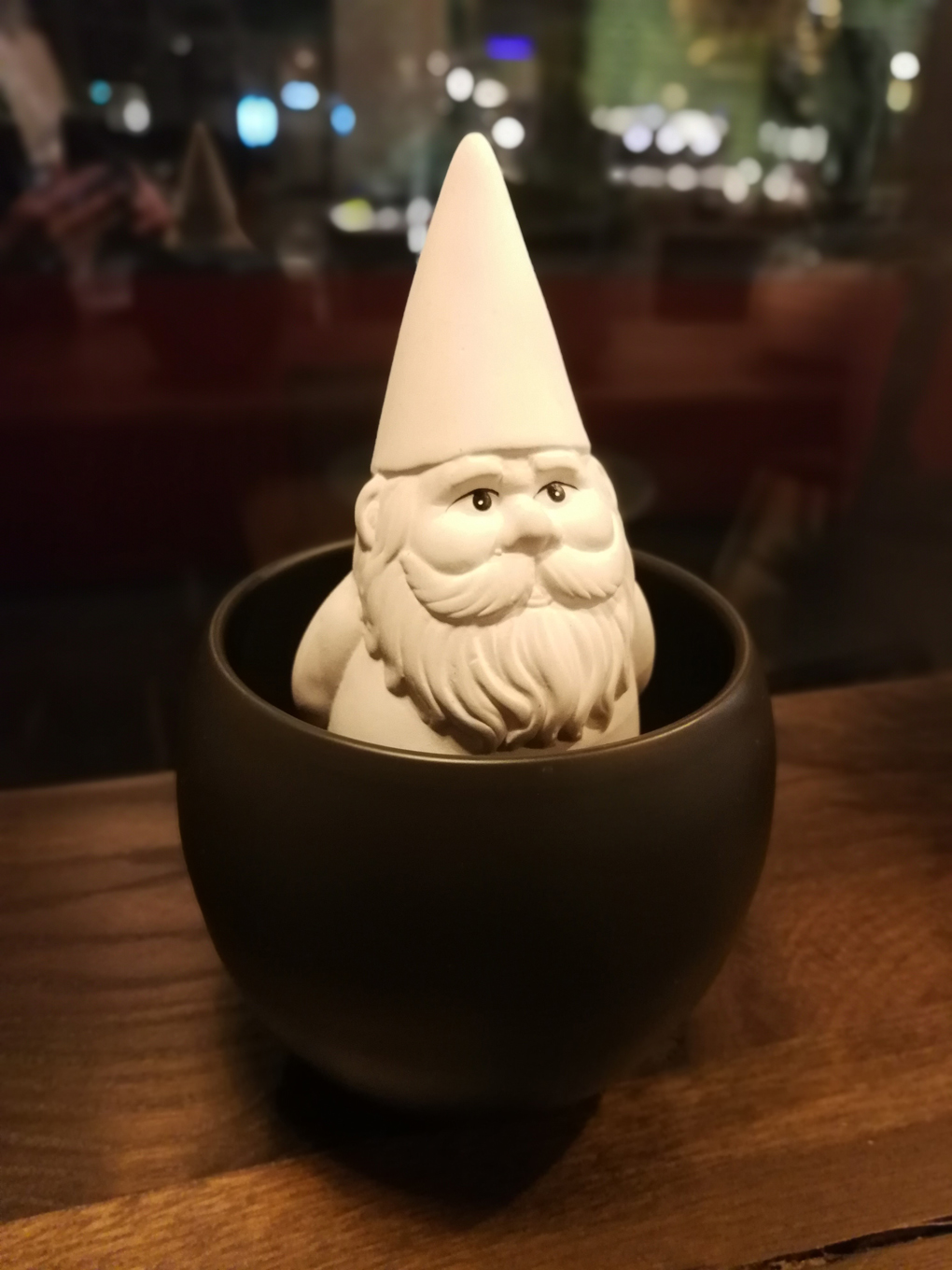 white gnome sitting in a small bowl