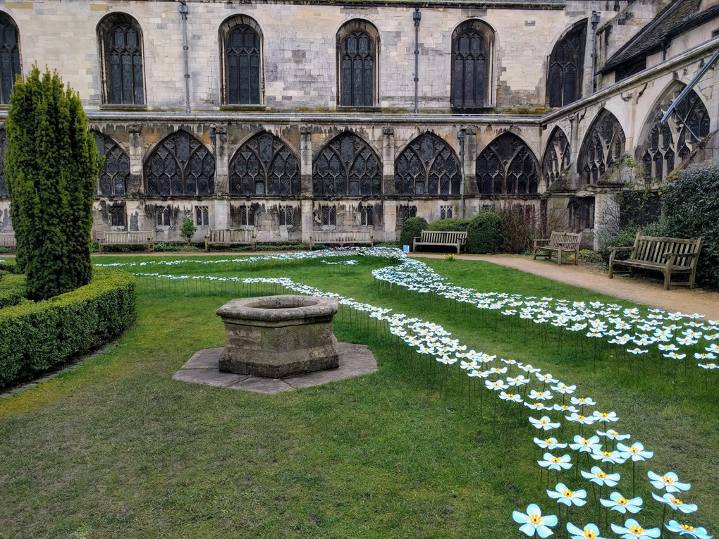 A display of metal forget-me-nots at Gloucester Cathedral.