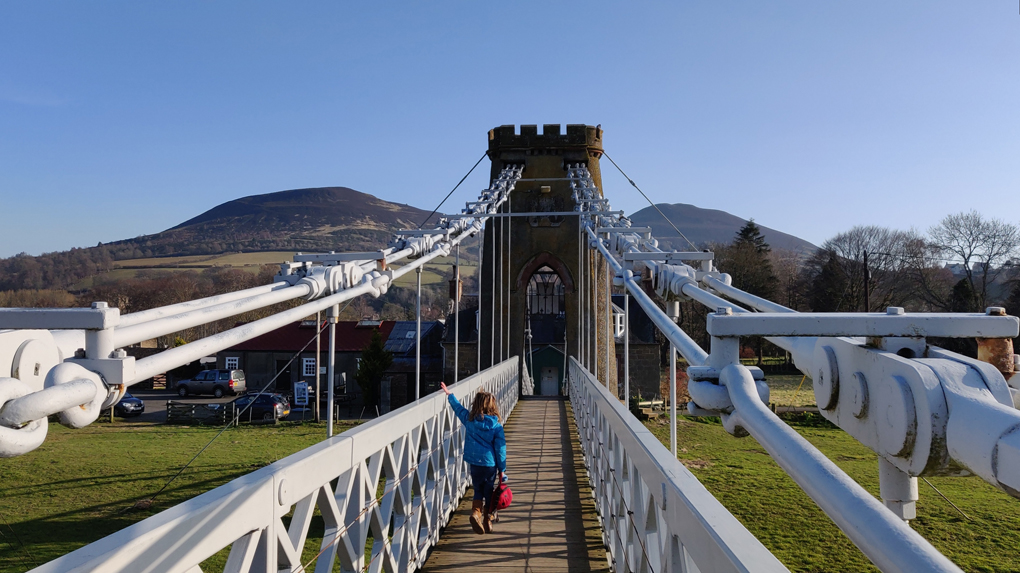 Crossing the Tweed on the Chain Bridge, Melrose, with the Eildon Hills beyond