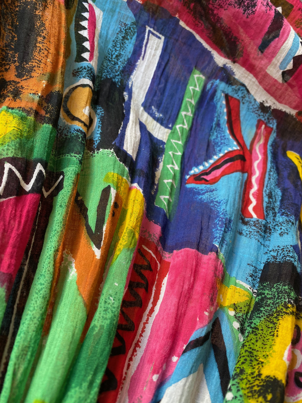 Close-up of fabric showing multicoloured letters
