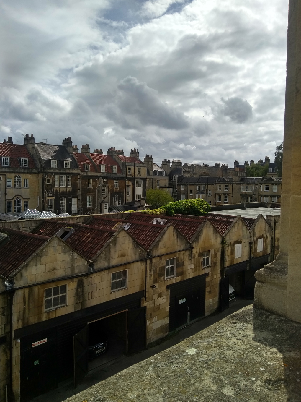 Rows of houses viewed from the back through a window.