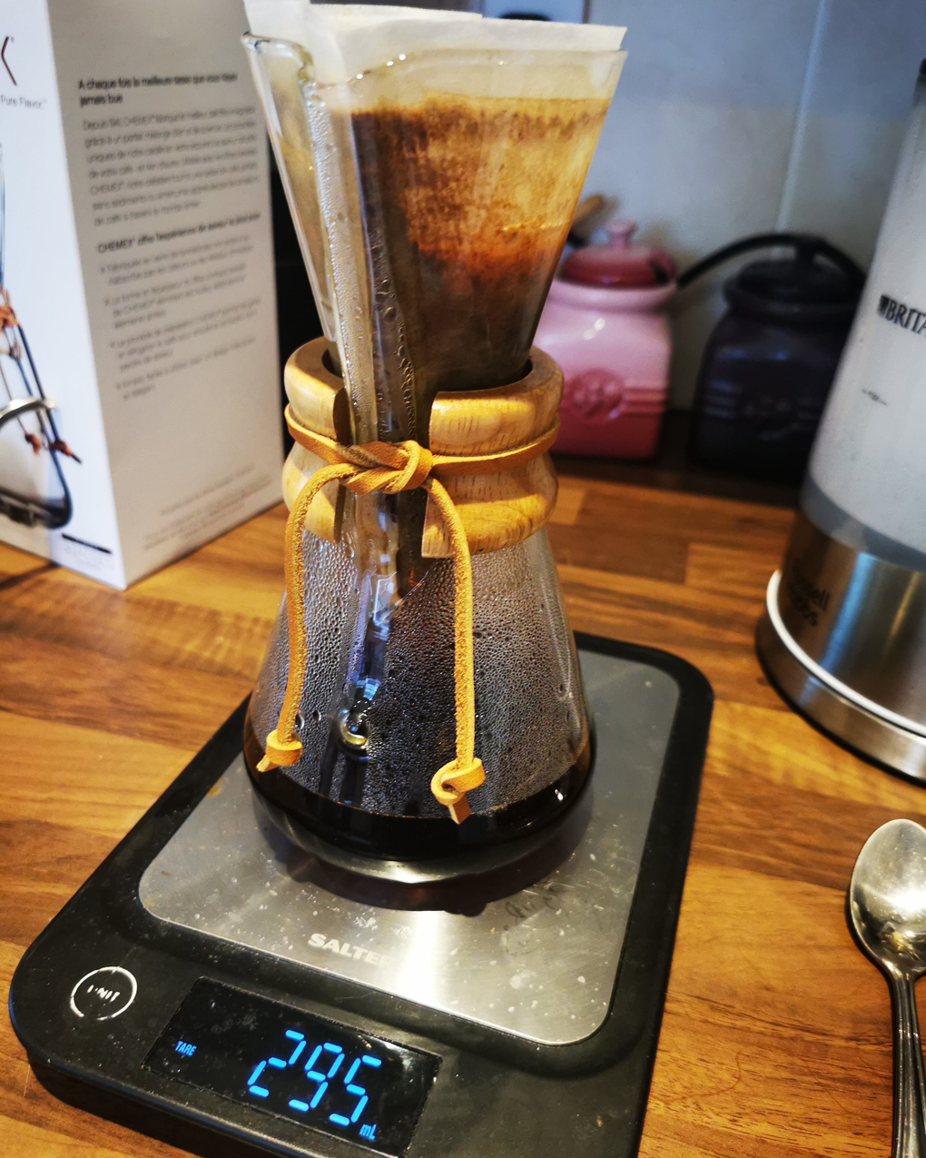 A chemex coffee filter coffee maker sat on a set of scales which reads 295 millilitres