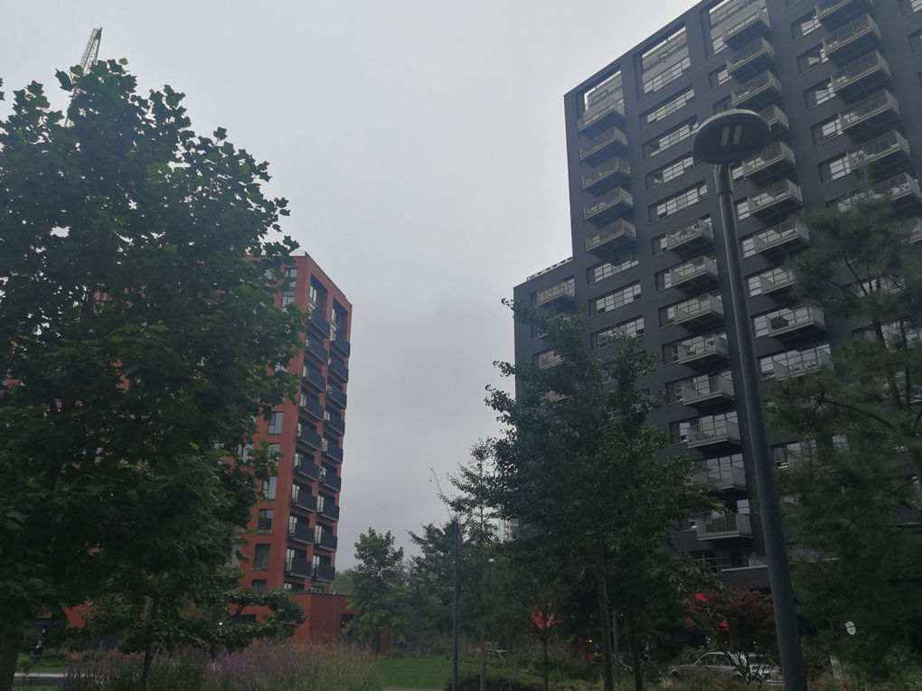 view between two high rise blocks of flats on a grey misty day