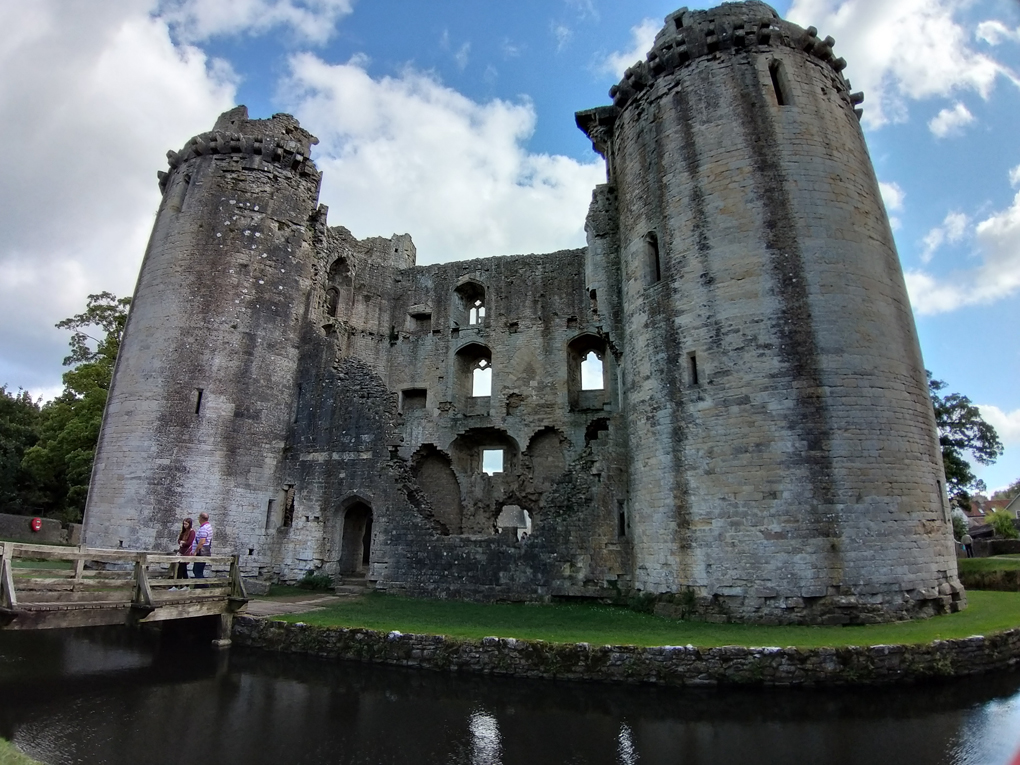 Castle with moat in the sunlight.