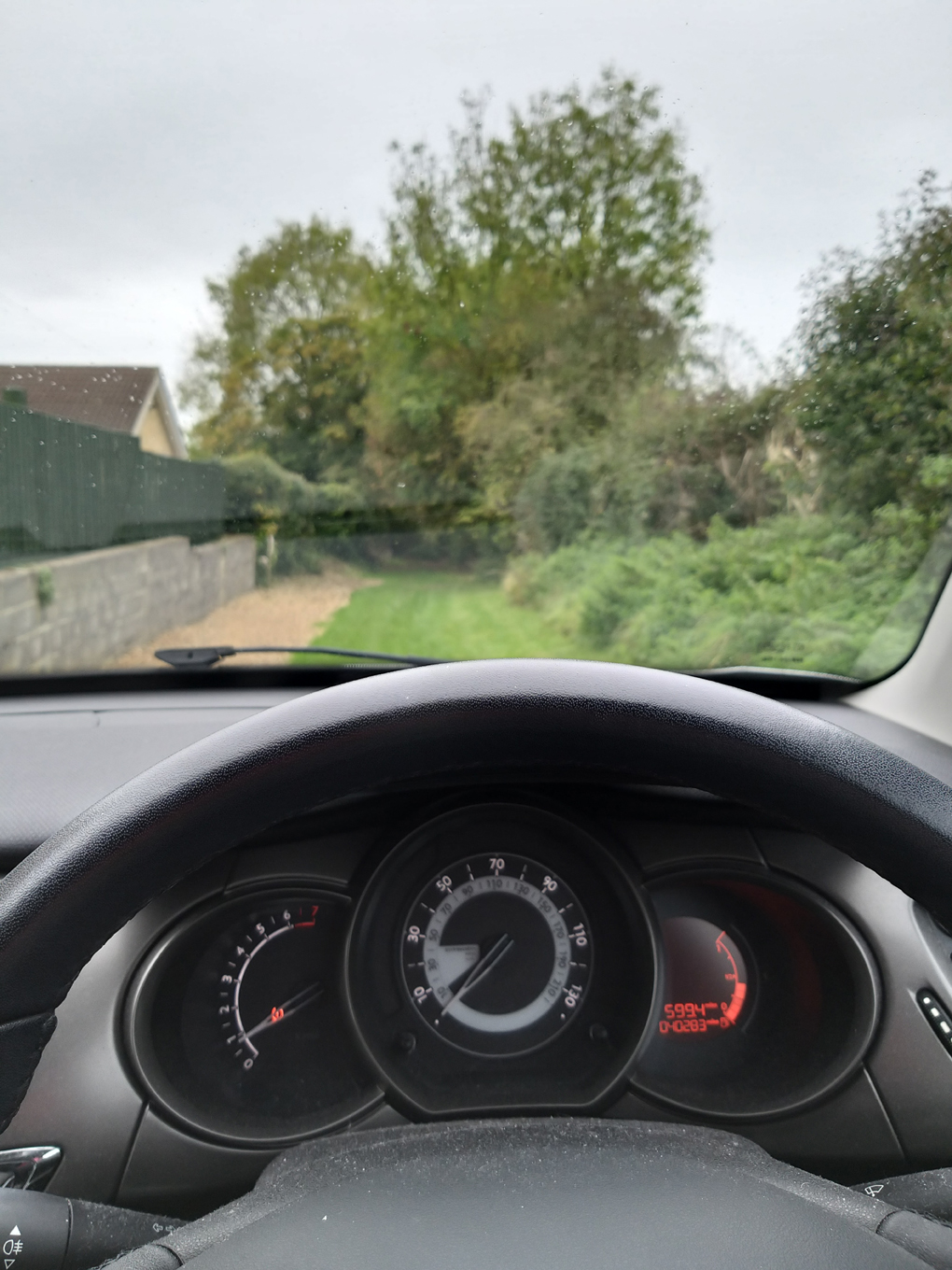View of a grassy bridle way from my car windscreen